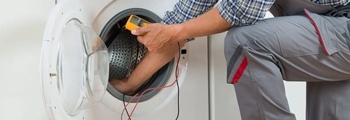 Dryer repair technician inspecting and repairing a clothes dryer in Dallas, TX